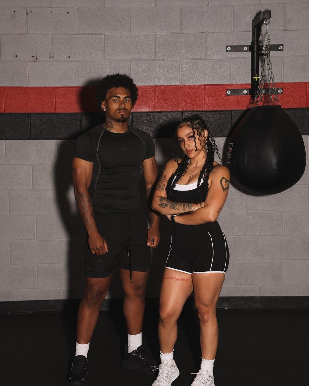Two models in ALPHA black at the speed bag